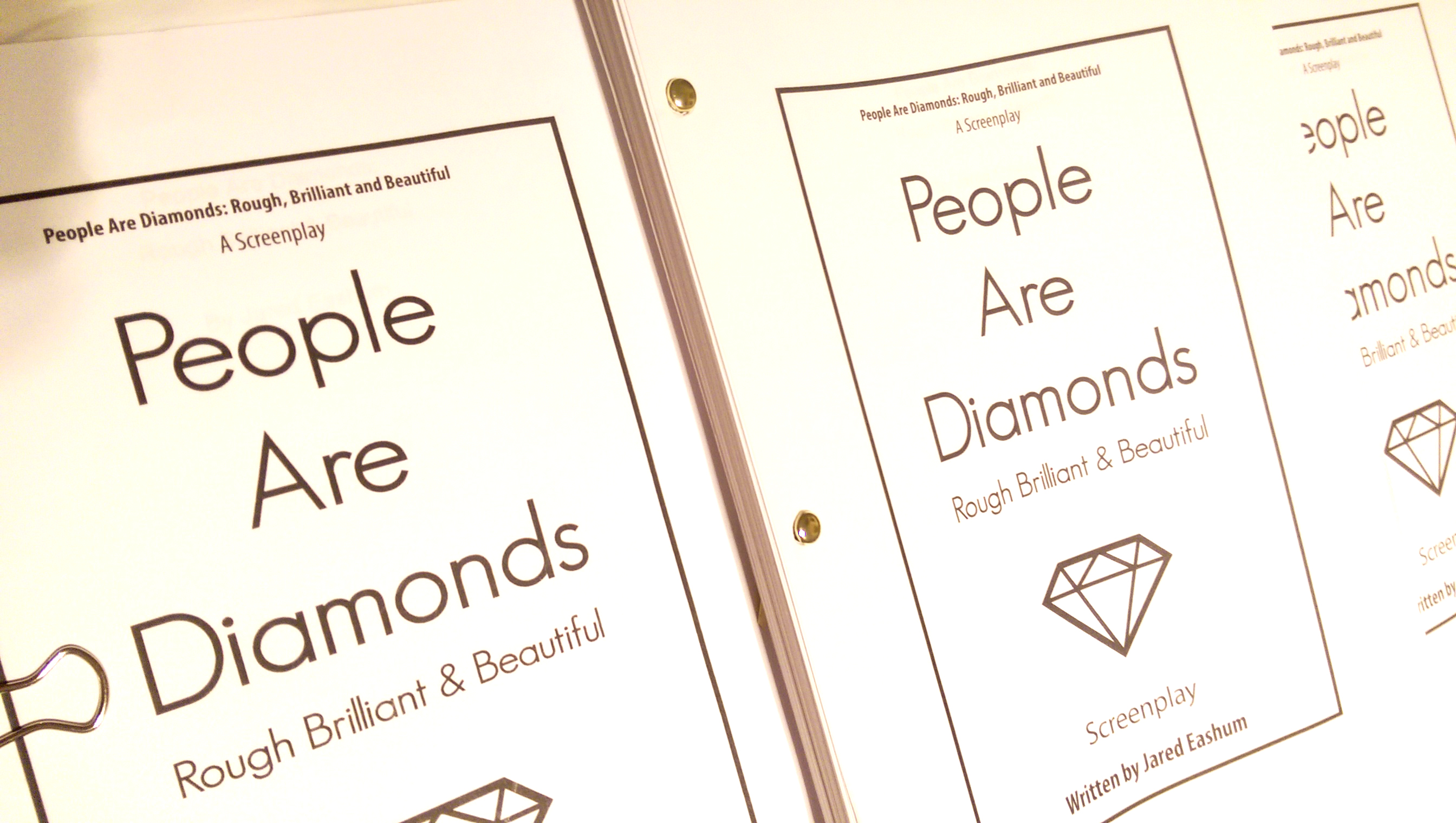 This is a picture of printed copies of the script, for the screenplay "People Are Diamonds: Rough Brilliant & Beautiful", written by Jared Eashum.